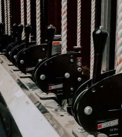 image of black rope locking devices in a backstage theater